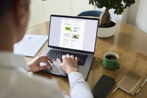 Man browsing job listing on laptop at home